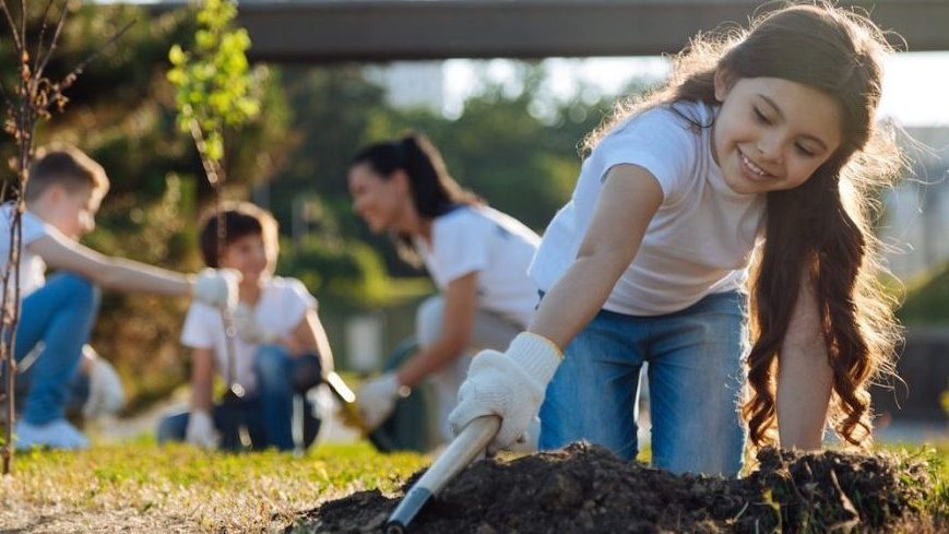 kid volunteers planting garden