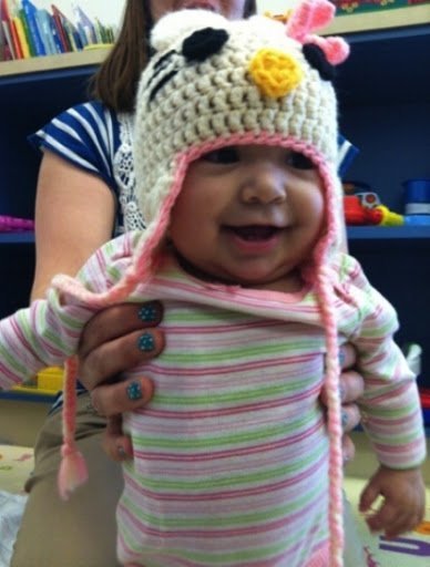 baby smiling with crocheted beanie