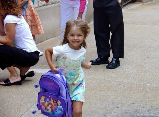 little girl running with backpack